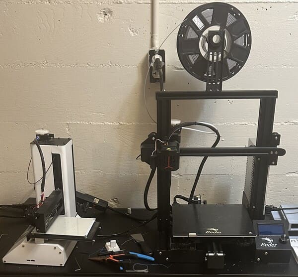 Two 3D printers a smaller one(left) for small prints and a larger one (right)
                    for larger prints