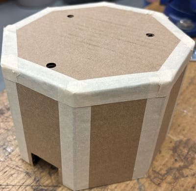 Initiale design shown with a cardboard prototype for my capstone project